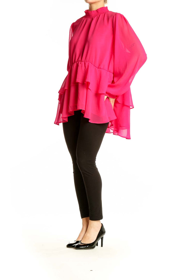 Front view of hot pink ruffled chiffon blouse from Torrid