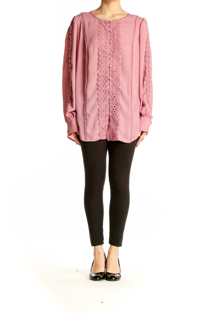 Front view of pink lace-trimmed polyester blouse from Torrid