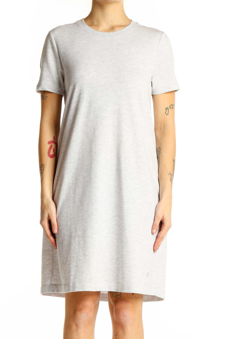 Front view of Sweaty Betty light gray t-shirt dress on model