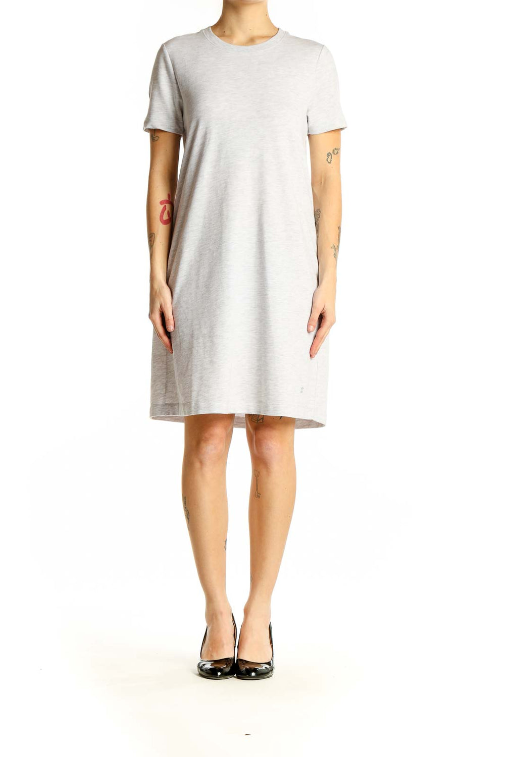 Front view of Sweaty Betty light gray t-shirt dress on model