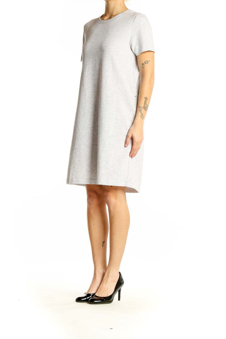 Front view of Sweaty Betty light gray t-shirt dress on model