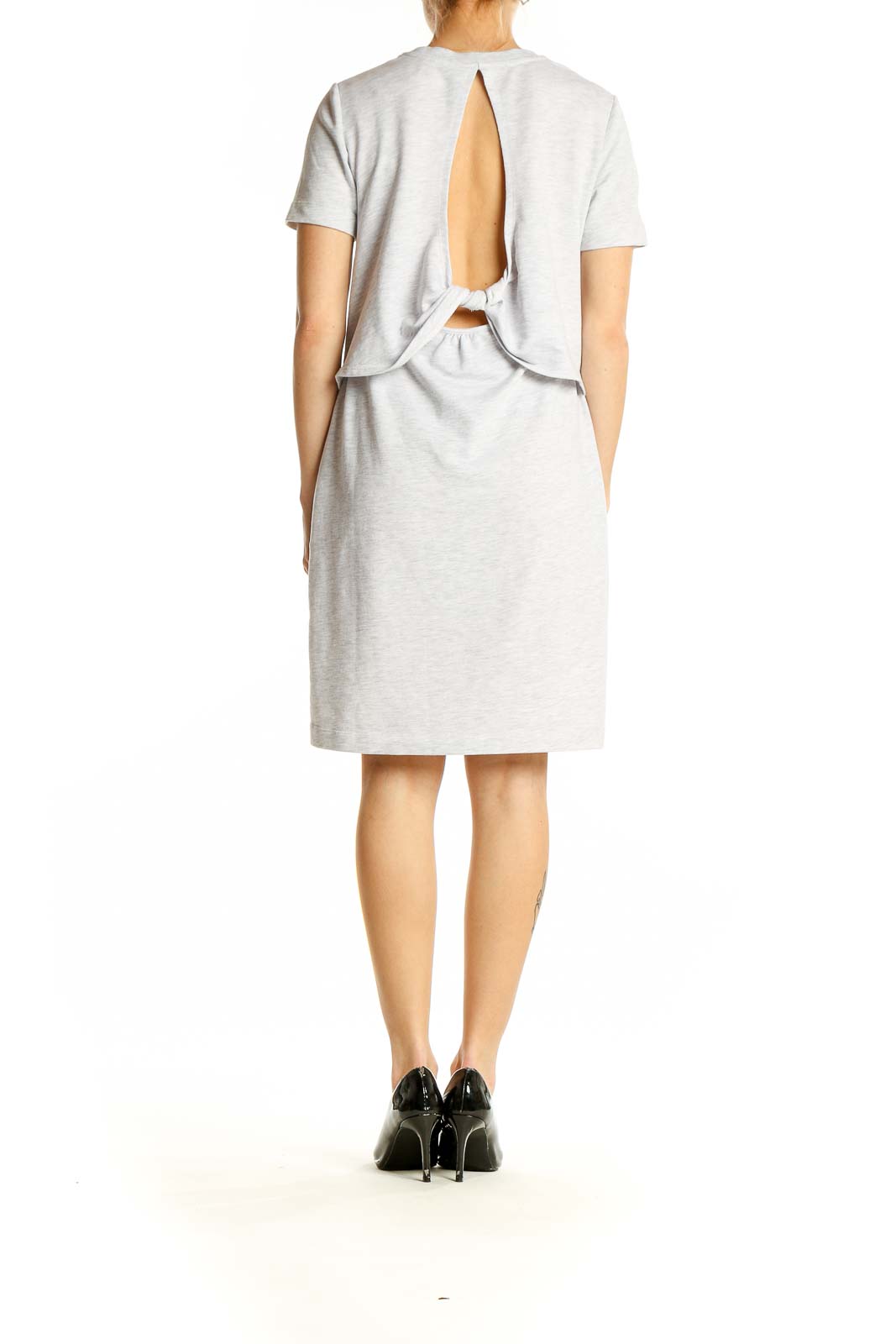 Side view of Sweaty Betty light gray t-shirt dress on model