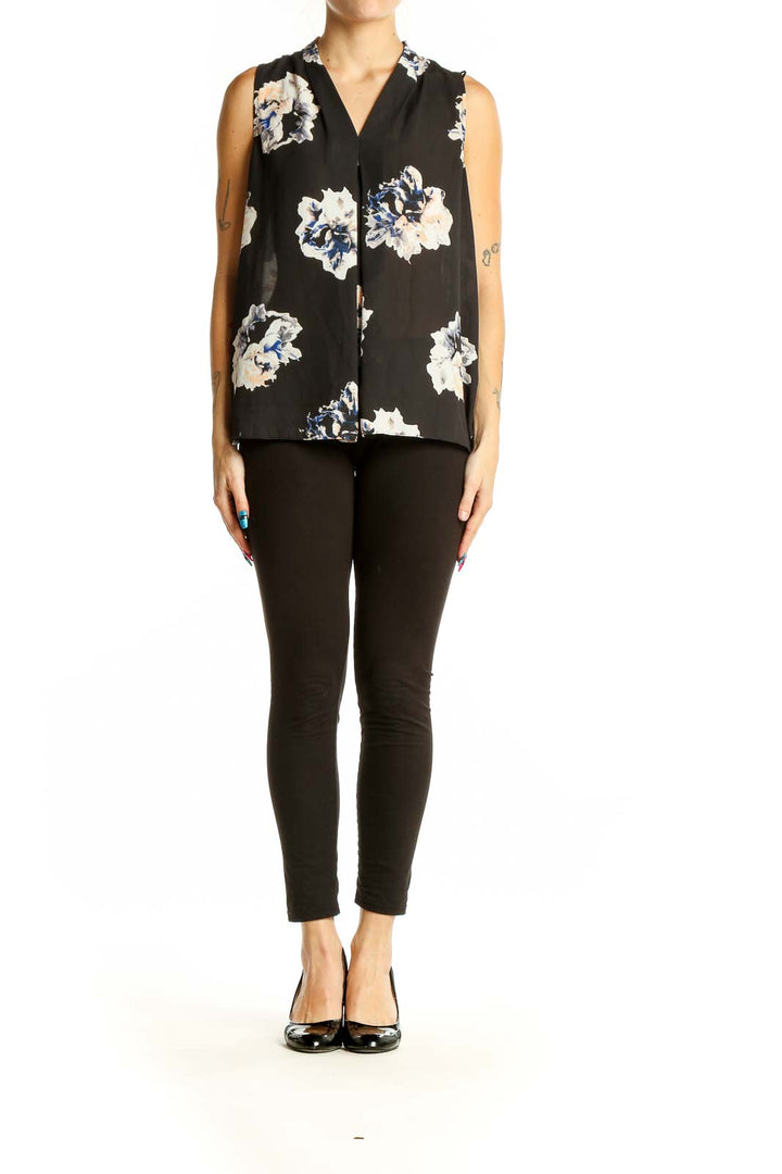 Front view of Vince Camuto black sleeveless blouse with white and blue floral print