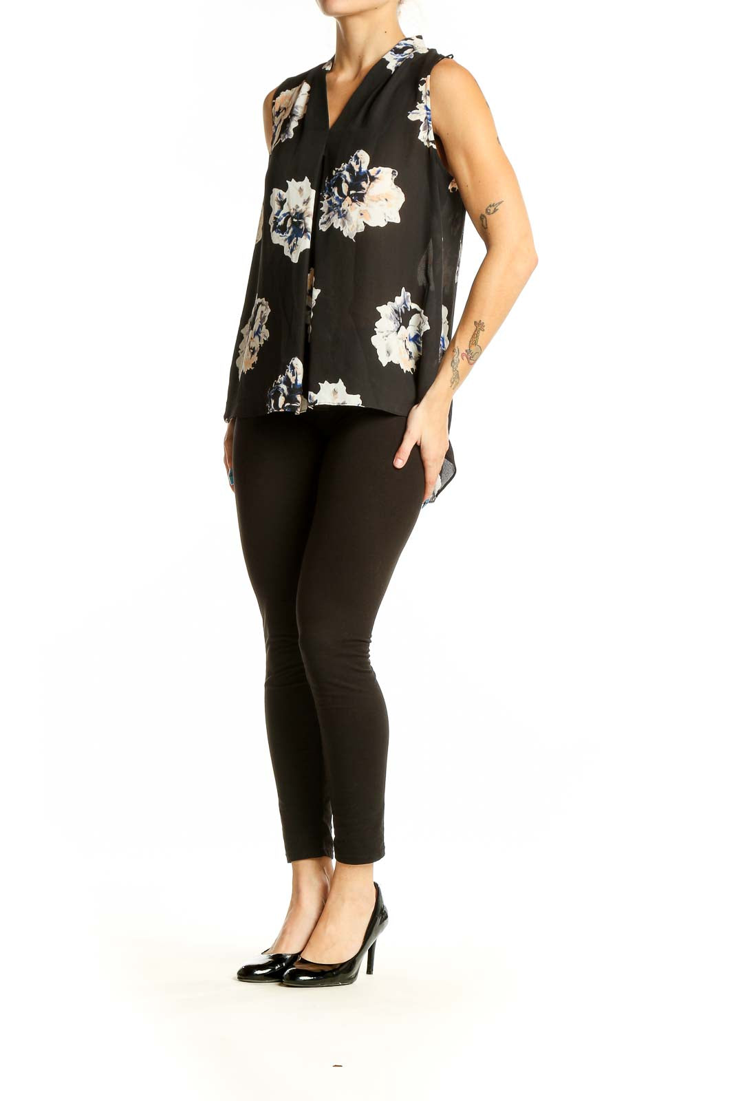 Front view of Vince Camuto black sleeveless blouse with white and blue floral print