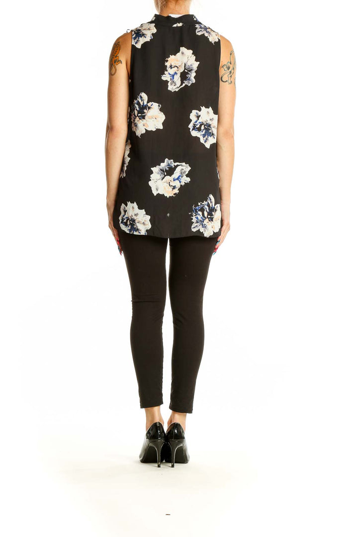 Back view of Vince Camuto black sleeveless blouse with white and blue floral print