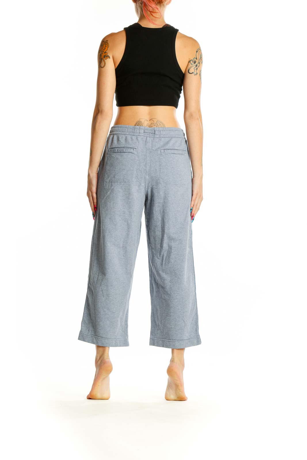 Side view of Athleta gray wide-leg cropped pants with black crop top