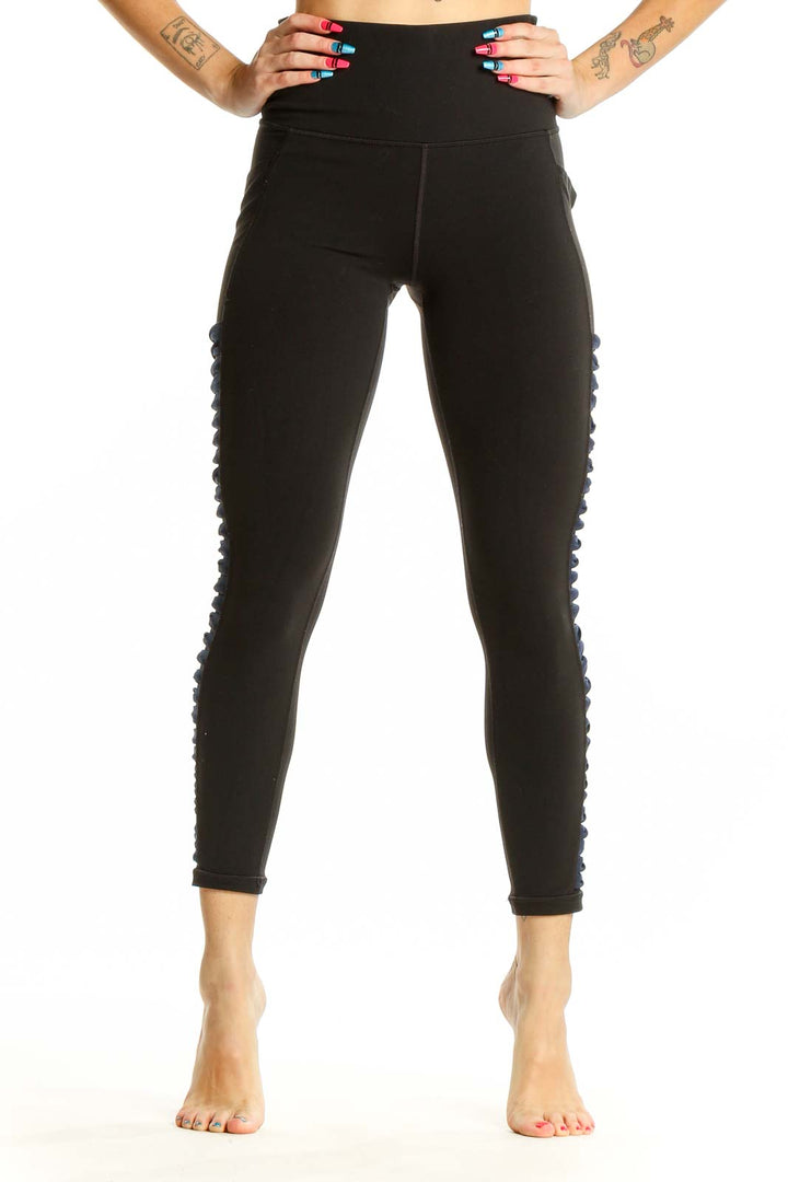 Front view of black Athleta high-waisted leggings with side detailing