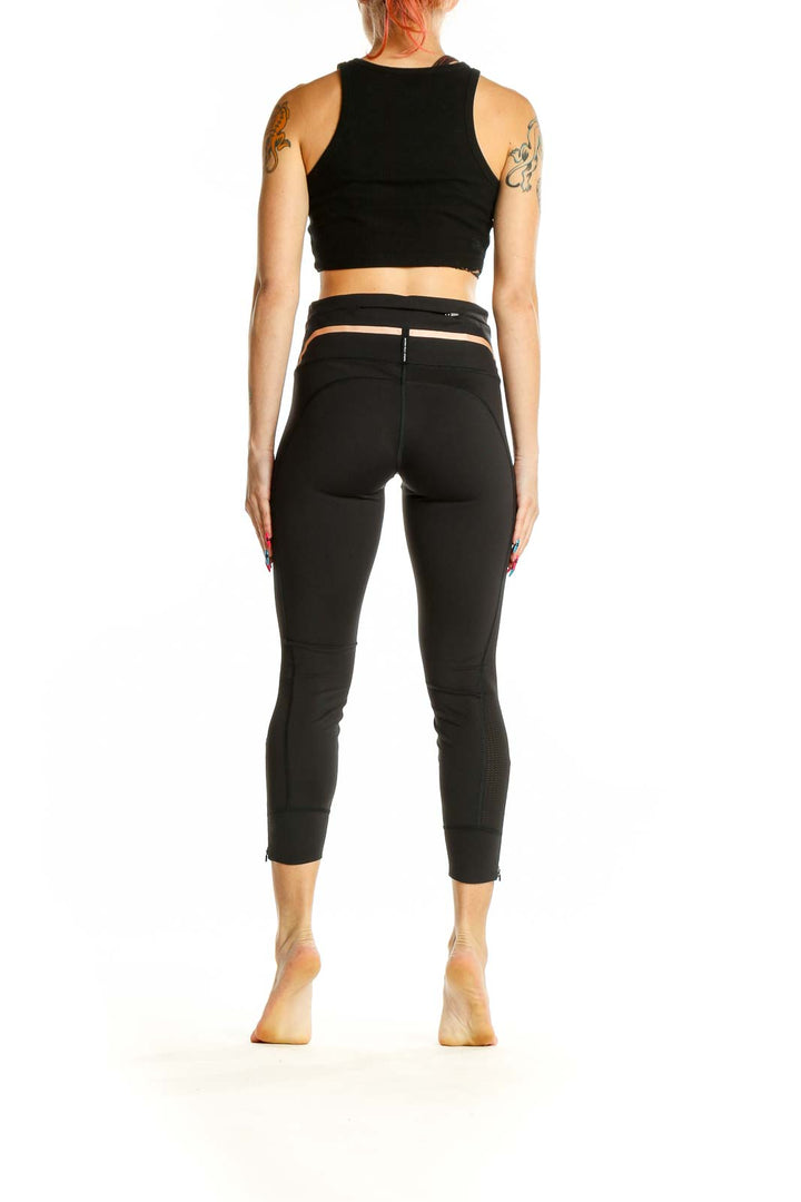 Side view of woman wearing Athleta black activewear set