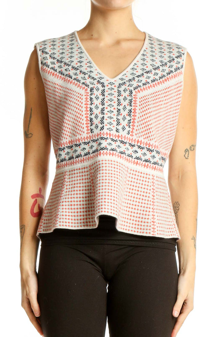 Front view of BCBG MaxAzria white sleeveless peplum top with coral dots and teal patterns