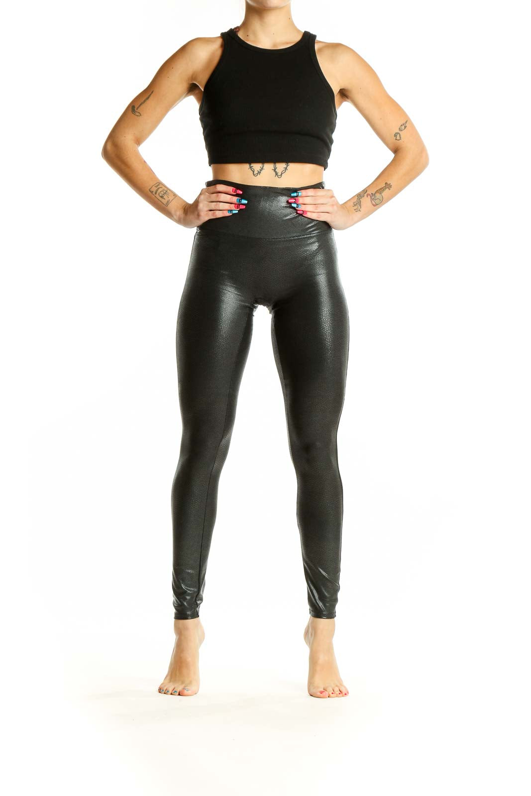 Front view of Spanx black faux leather high-waisted leggings on model