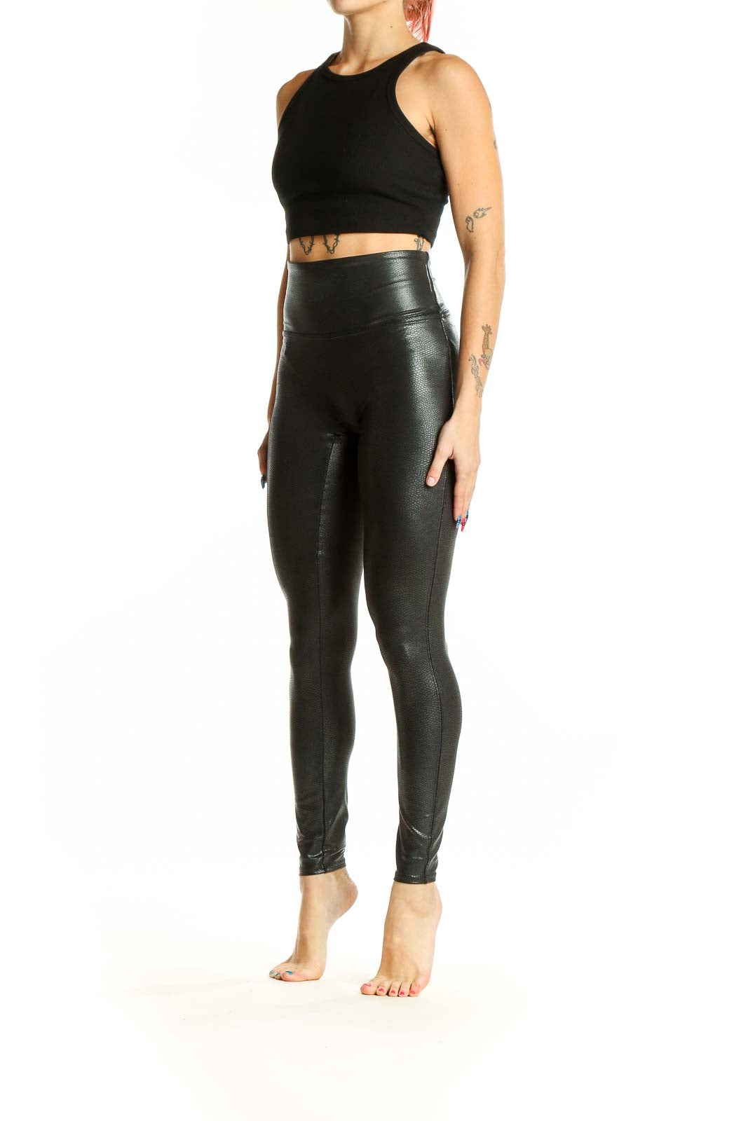 Front view of Spanx black faux leather high-waisted leggings on model