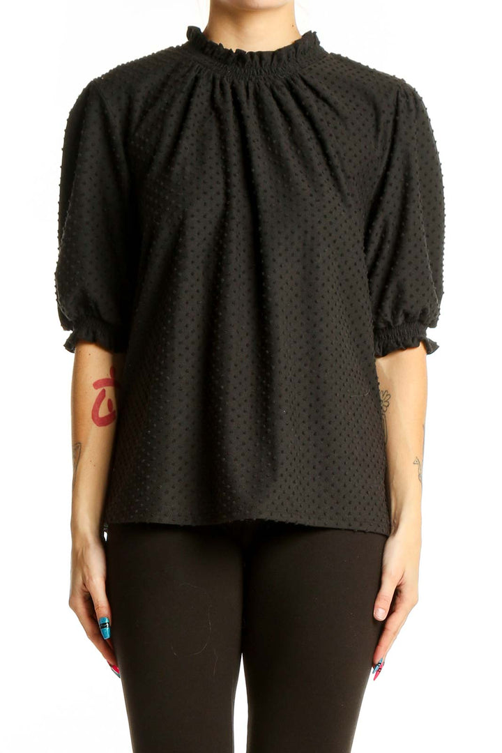 Front view of J.Crew black textured top with puff sleeves