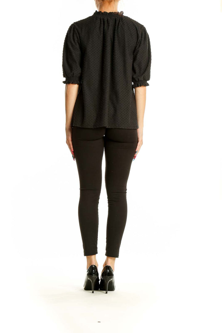 Back view of J.Crew black textured top on model