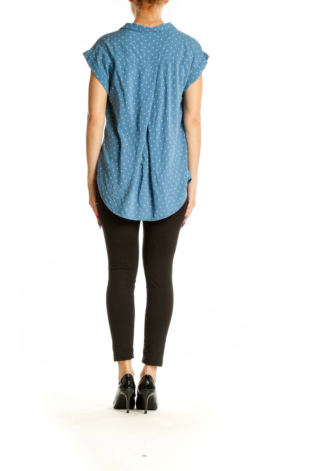 Side view of model wearing Jachs Girlfriend blue polka dot rayon button-up blouse with black pants