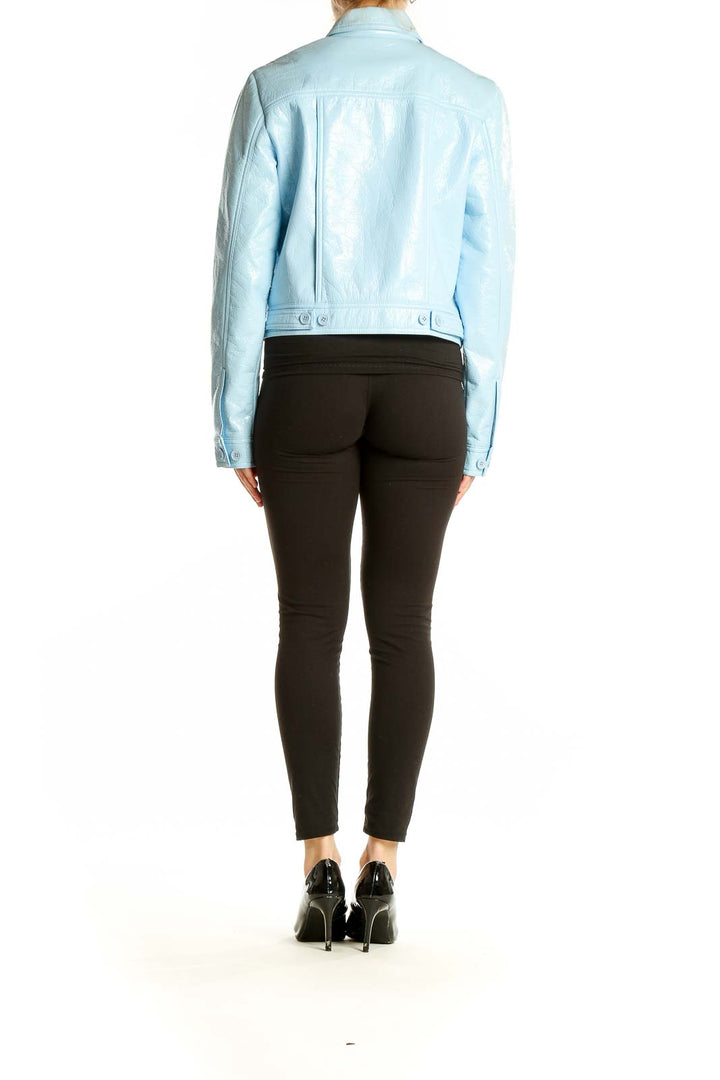 Side view of NAF NAF sky blue faux patent leather cropped jacket on model