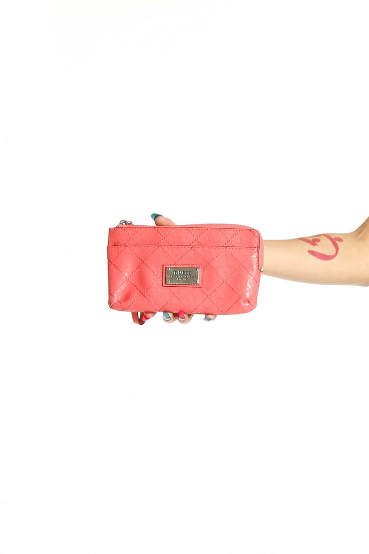 Front view of coral quilted Guess zip clutch