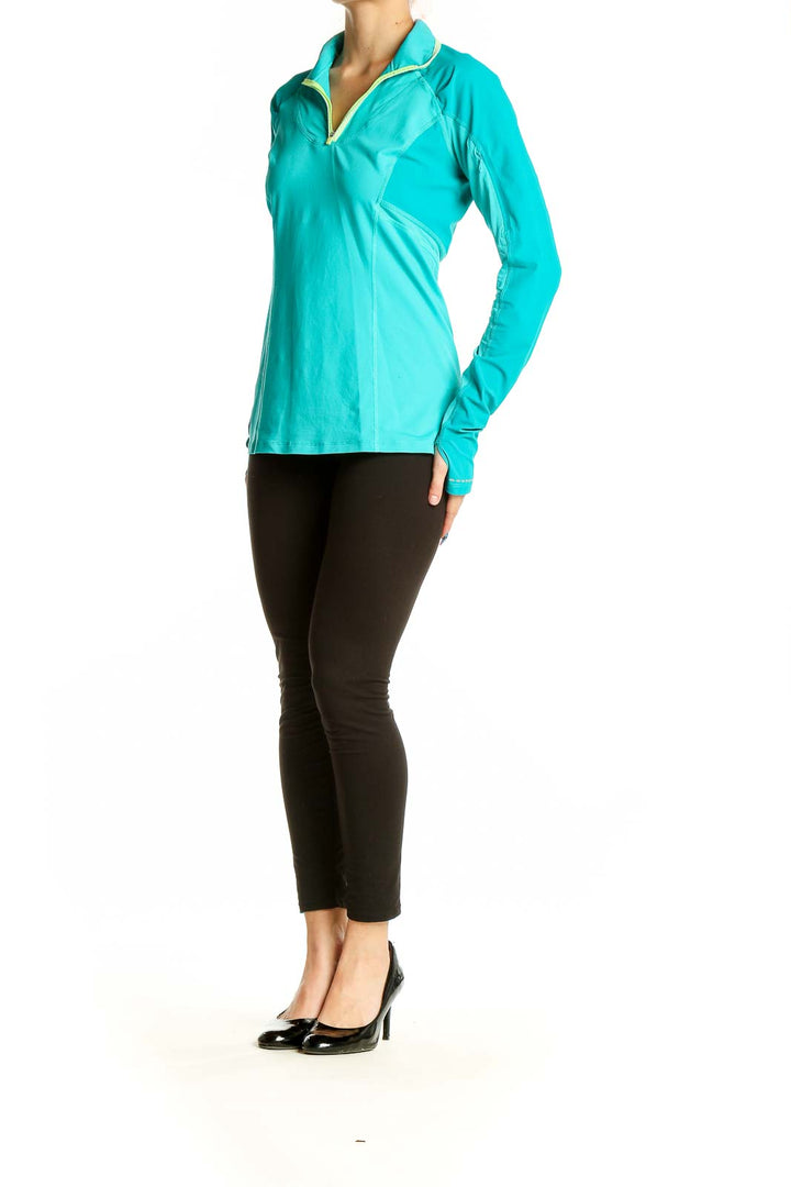 Front view of teal Lululemon quarter-zip athletic top