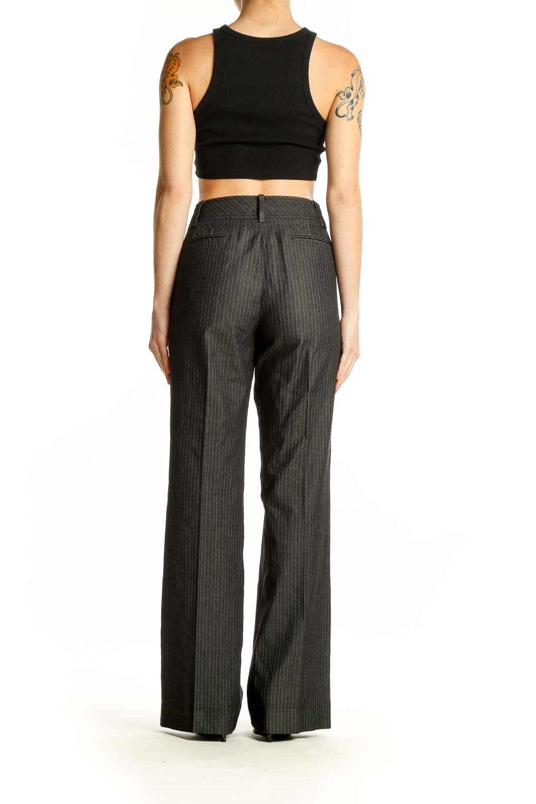 Side view of model wearing Ann Taylor LOFT gray pinstriped wide-leg trousers