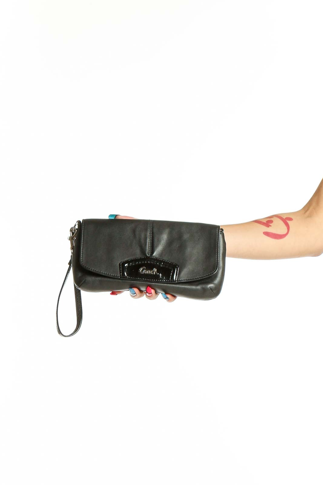 Front view of black leather Coach wristlet clutch with signature hardware