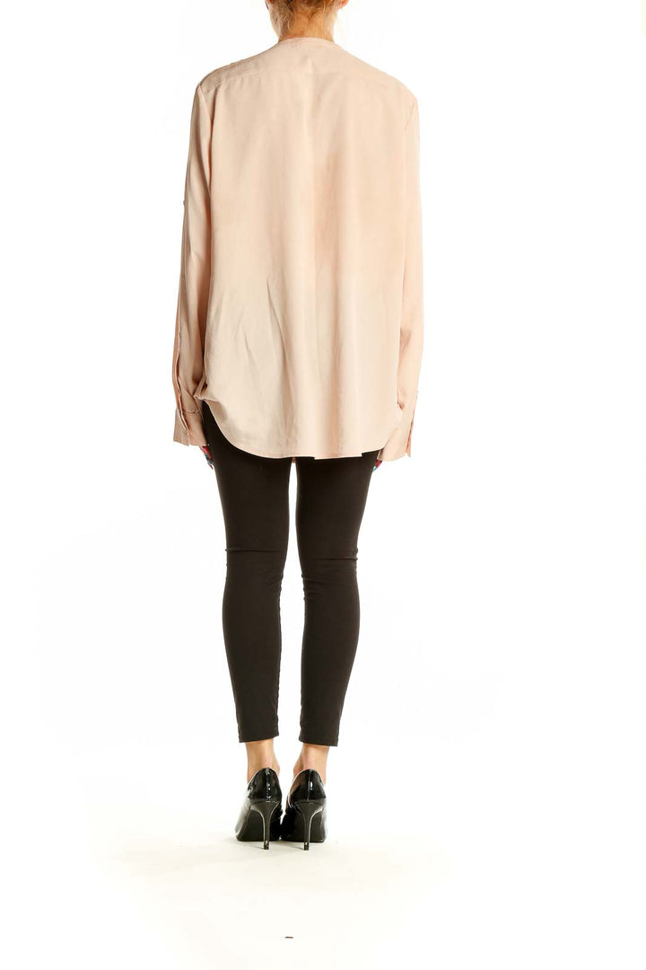 Side view of Calvin Klein blush polyester blouse showing relaxed fit and long sleeves