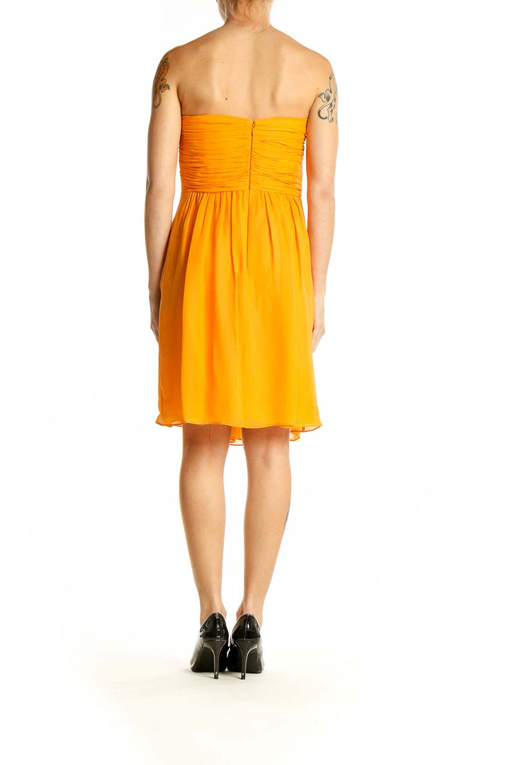 Side view of yellow strapless ruched cocktail dress by Shoshanna