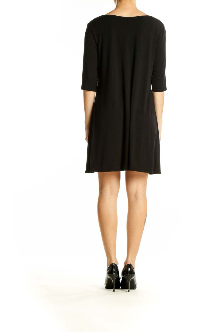 Side view of Eileen Fisher black V-neck flowy tunic top on model