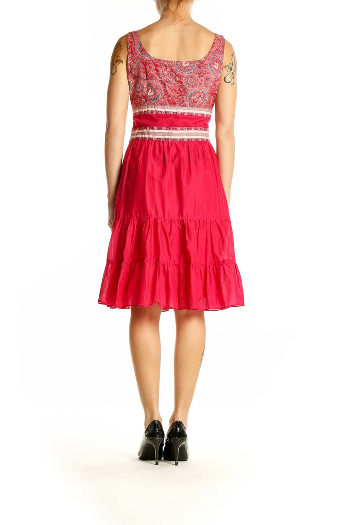 Side view of Anna Sui red cotton sundress showing paisley bodice and tiered skirt