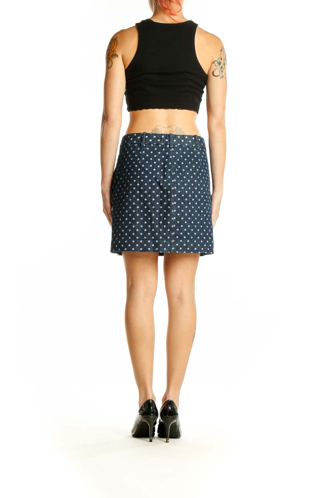 Side view of J.Crew navy polka dot mini skirt showing pockets and length