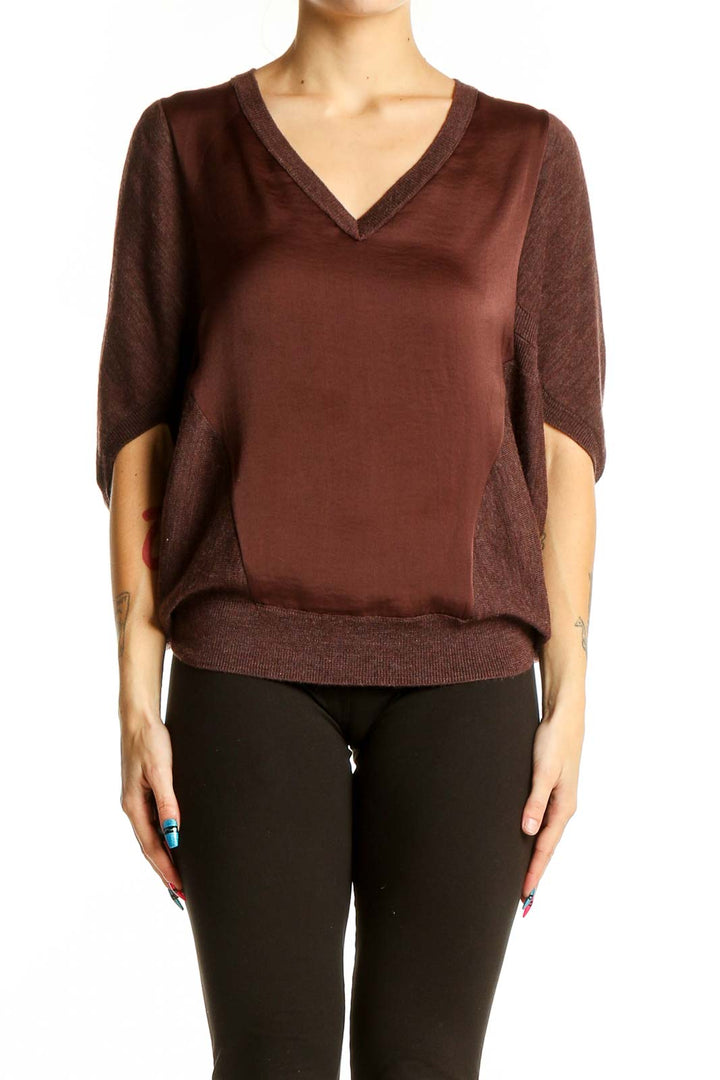 Front view of Allsaints brown V-neck blouse with dolman sleeves