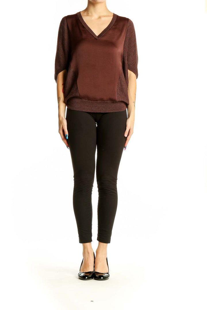 Front view of Allsaints brown V-neck blouse with dolman sleeves