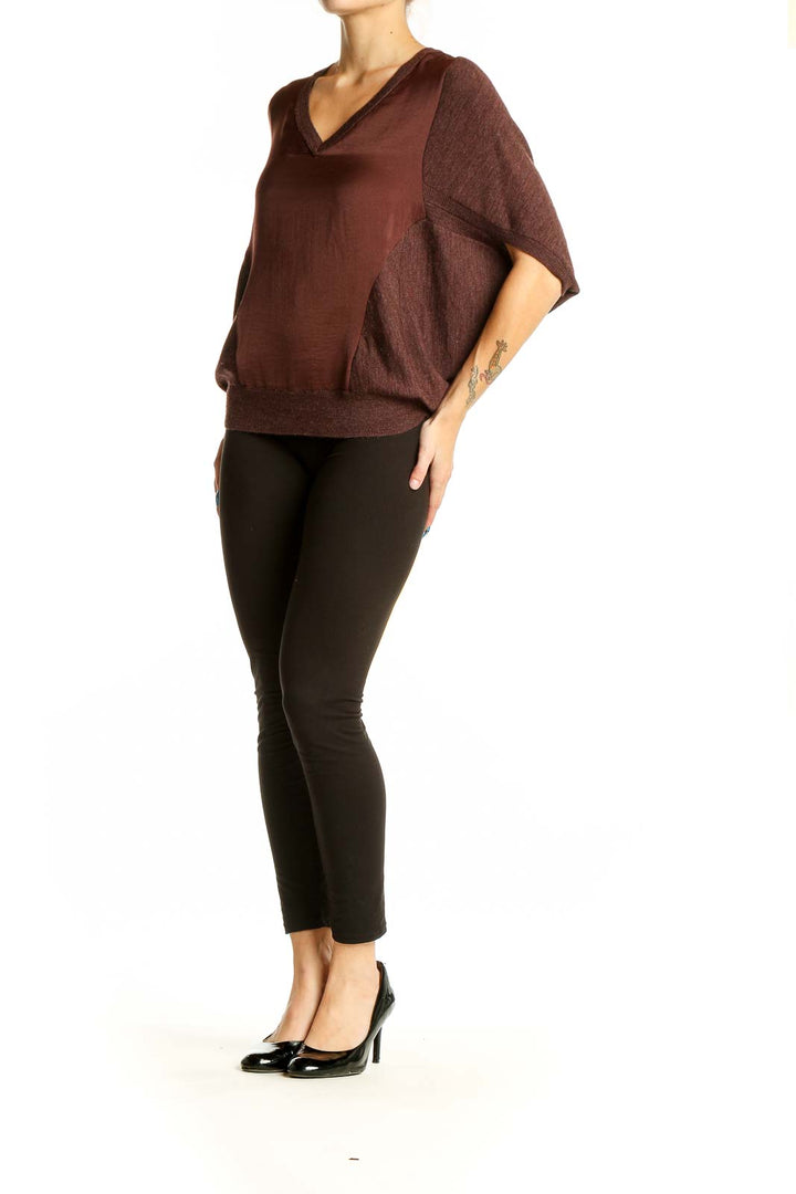 Front view of Allsaints brown V-neck blouse with dolman sleeves