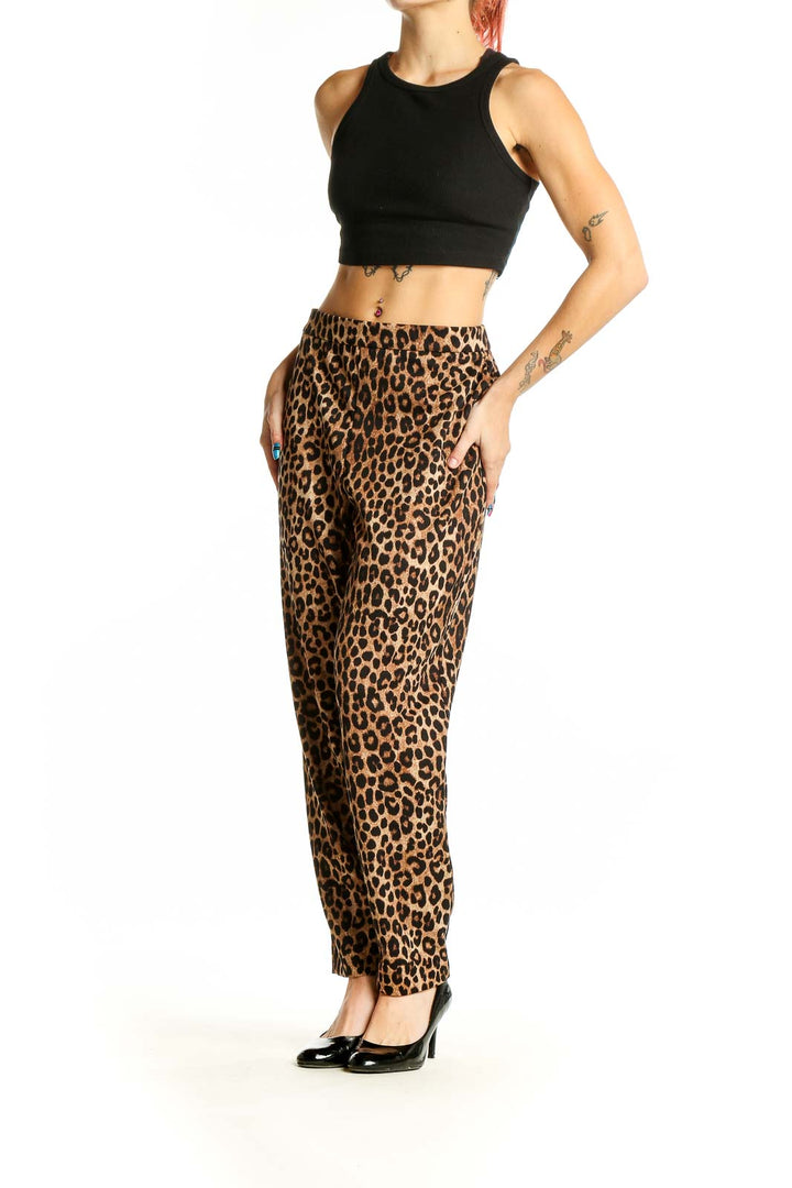 Front view of Michael Kors leopard print trousers on model