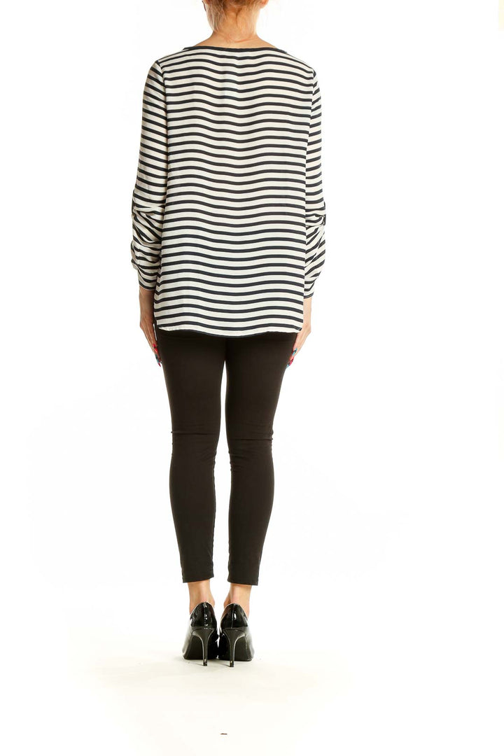 Back view of LOFT black and white striped polyester blouse showing longer hem