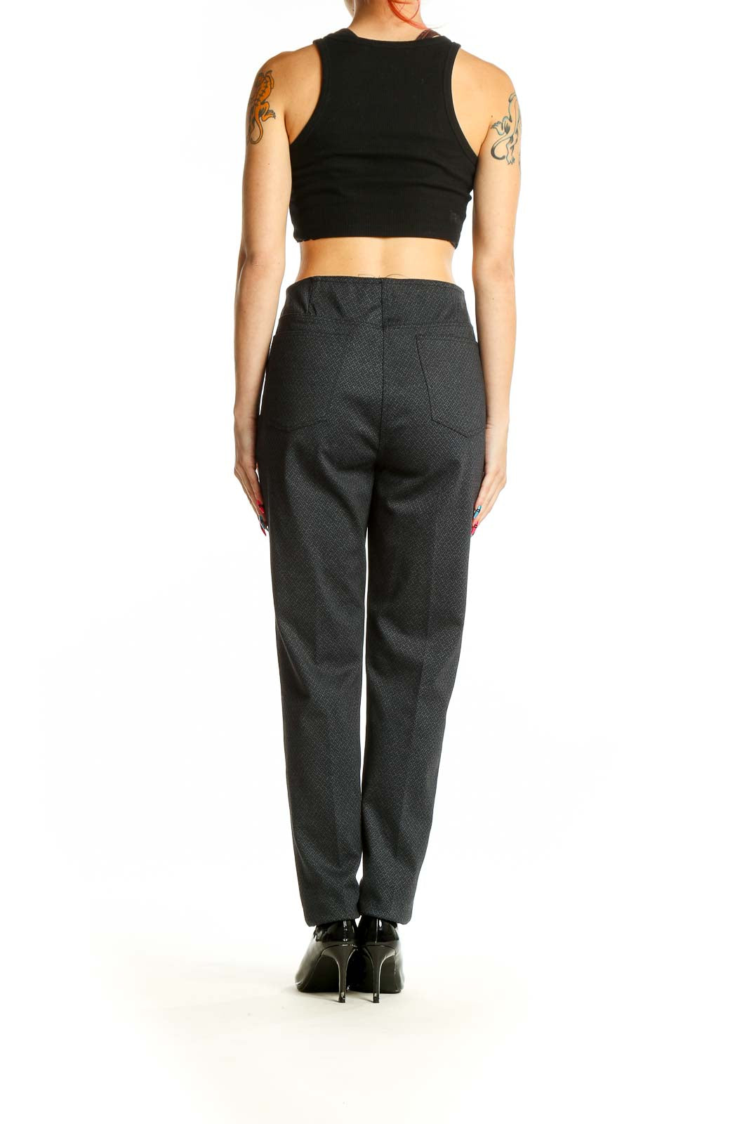 Back view of model wearing Neiman Marcus dark gray textured trousers with black top