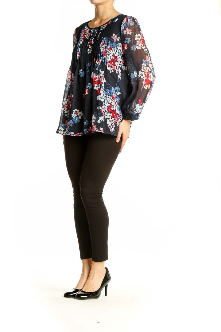 Front view of Tommy Hilfiger navy floral print sheer blouse with pleated detail