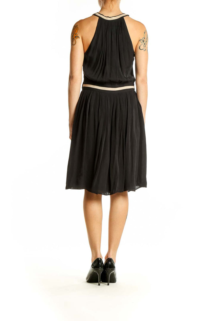 Side view of L'AGENCE black silk halter neck cocktail dress showing gathered waist