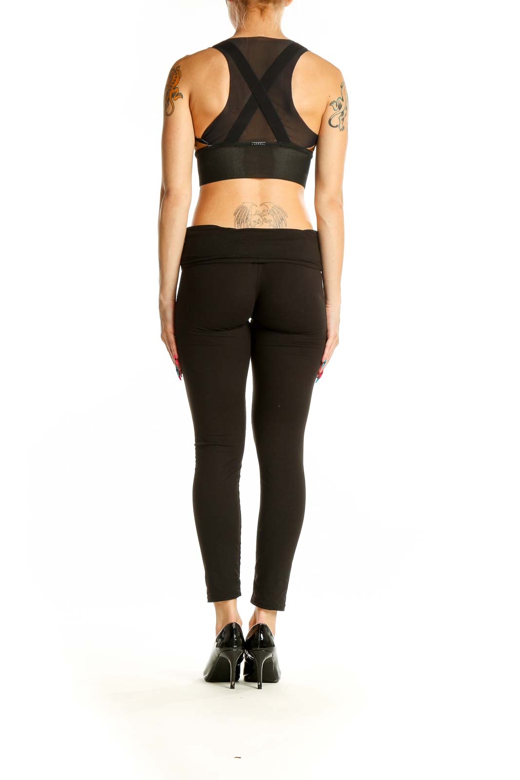 Side view of KORAL bronze metallic racerback sports bra with black leggings