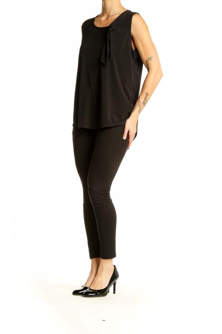 Front view of DKNY black sleeveless top with knot detail