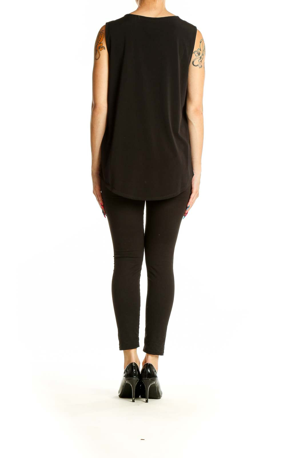 Full-length view of model wearing DKNY black sleeveless top with knot detail