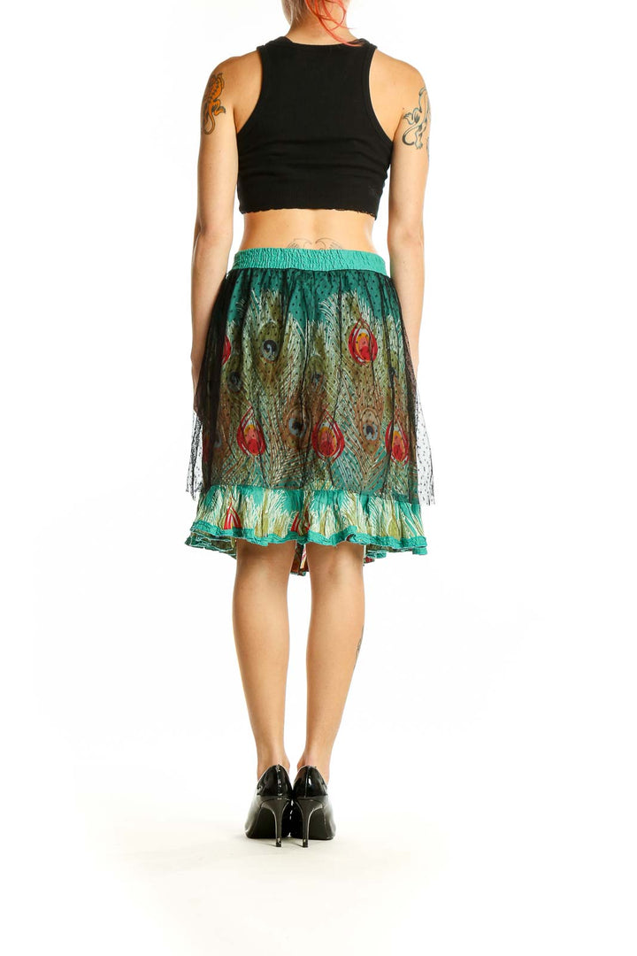 Side view of Desigual teal peacock feather print tulle skirt showing ruffle hem