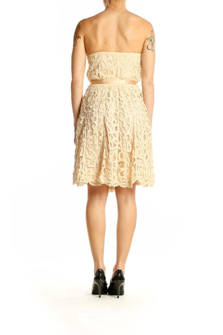 Side view of Betsey Johnson cream lace strapless cocktail dress showing A-line silhouette