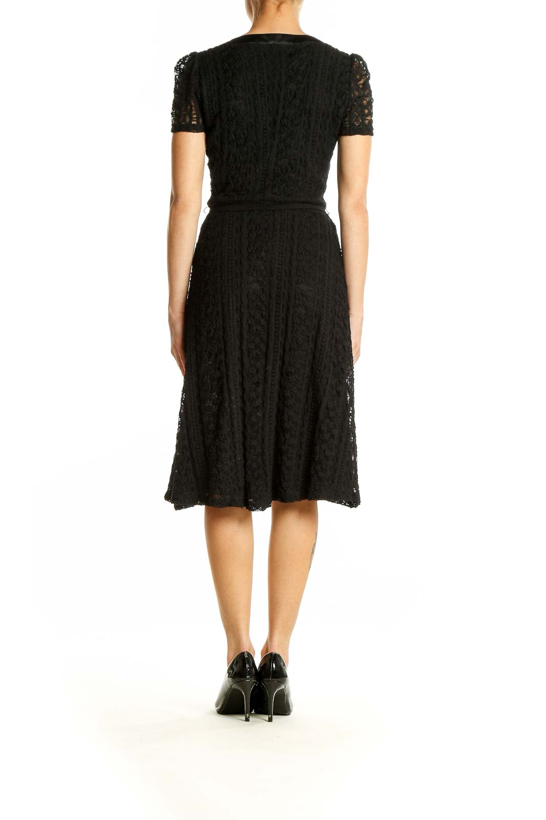 Side view of Betsy Johnson black lace midi dress showing tie waist detail