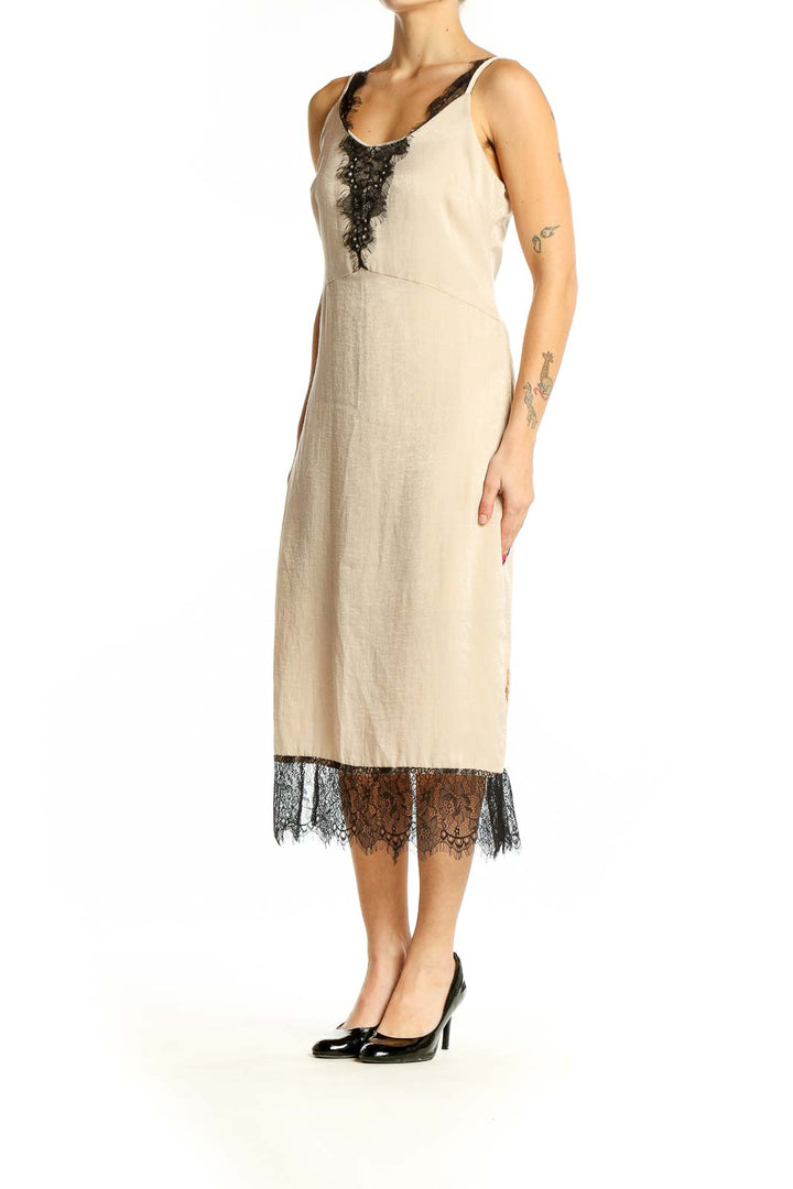 Front view of beige RESERVED midi slip dress with black lace trim