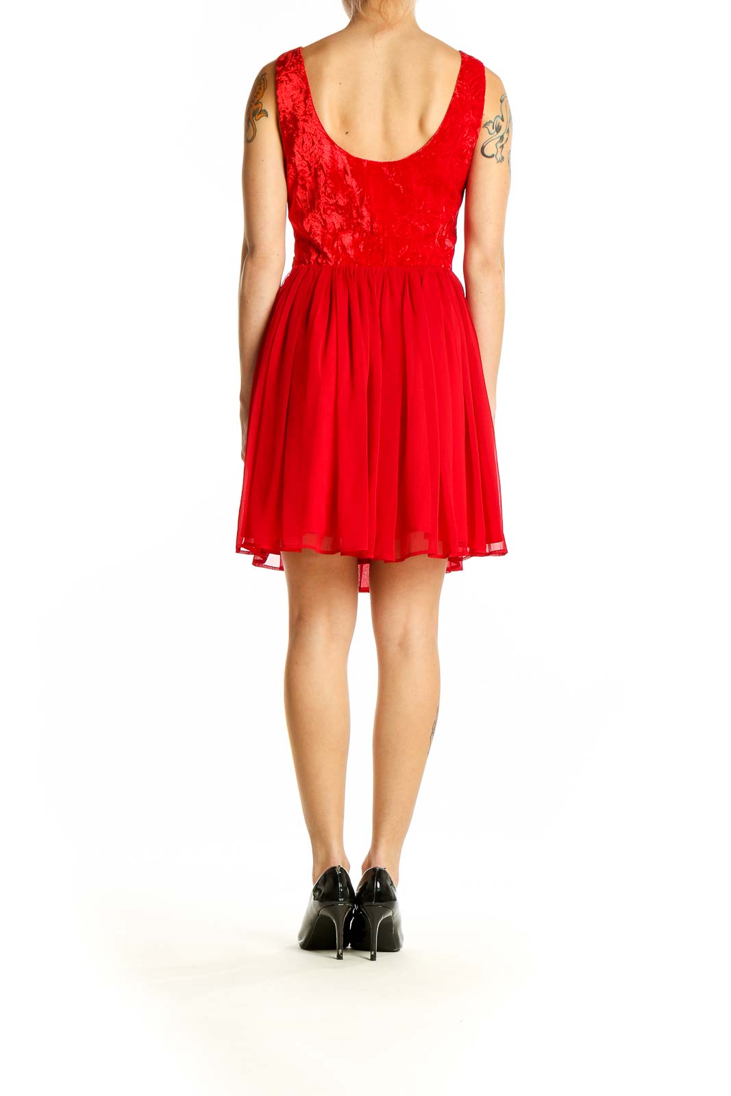 Side view of red Free People cocktail dress showing ruched waist and flowy skirt