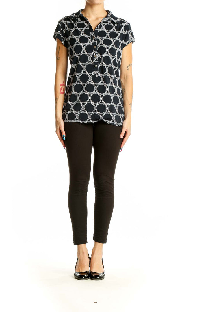 Front view of Alfani black and white geometric print polo top