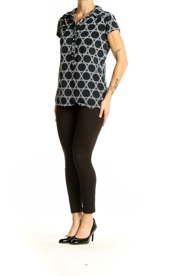 Front view of Alfani black and white geometric print polo top