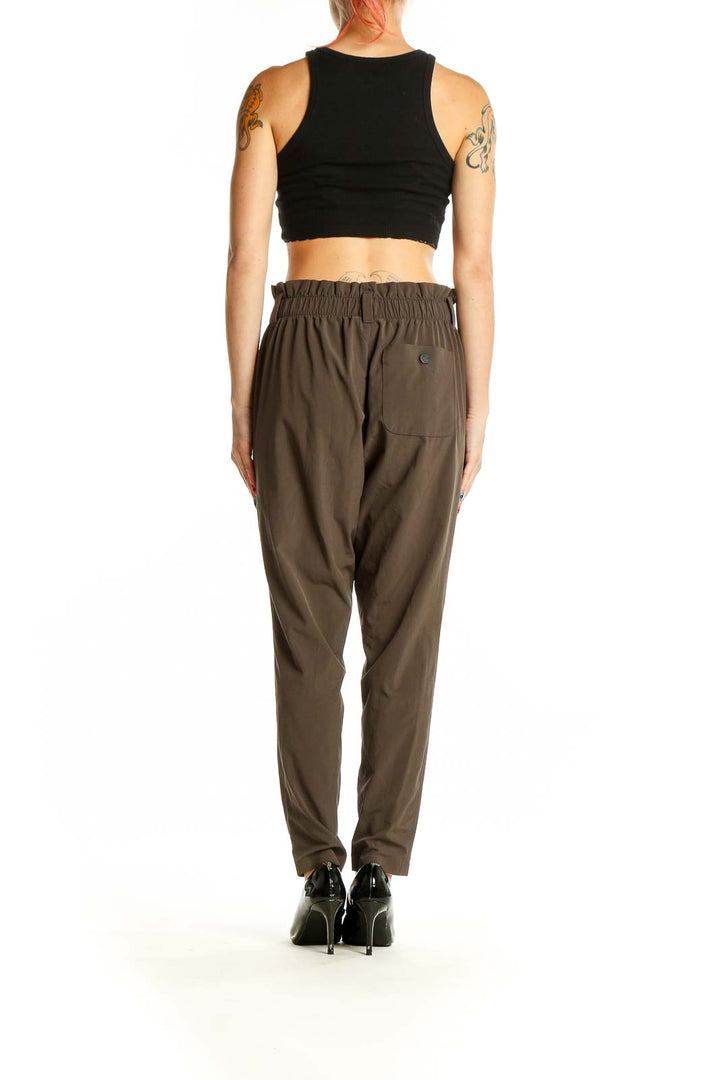 Side view of model wearing Athleta olive relaxed fit cargo pants with black top