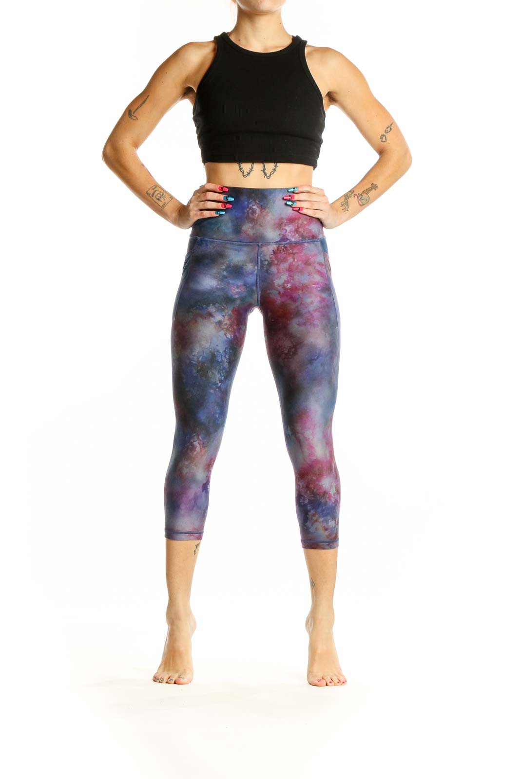 Front view of Athleta cosmic tie-dye capri leggings in blue and pink