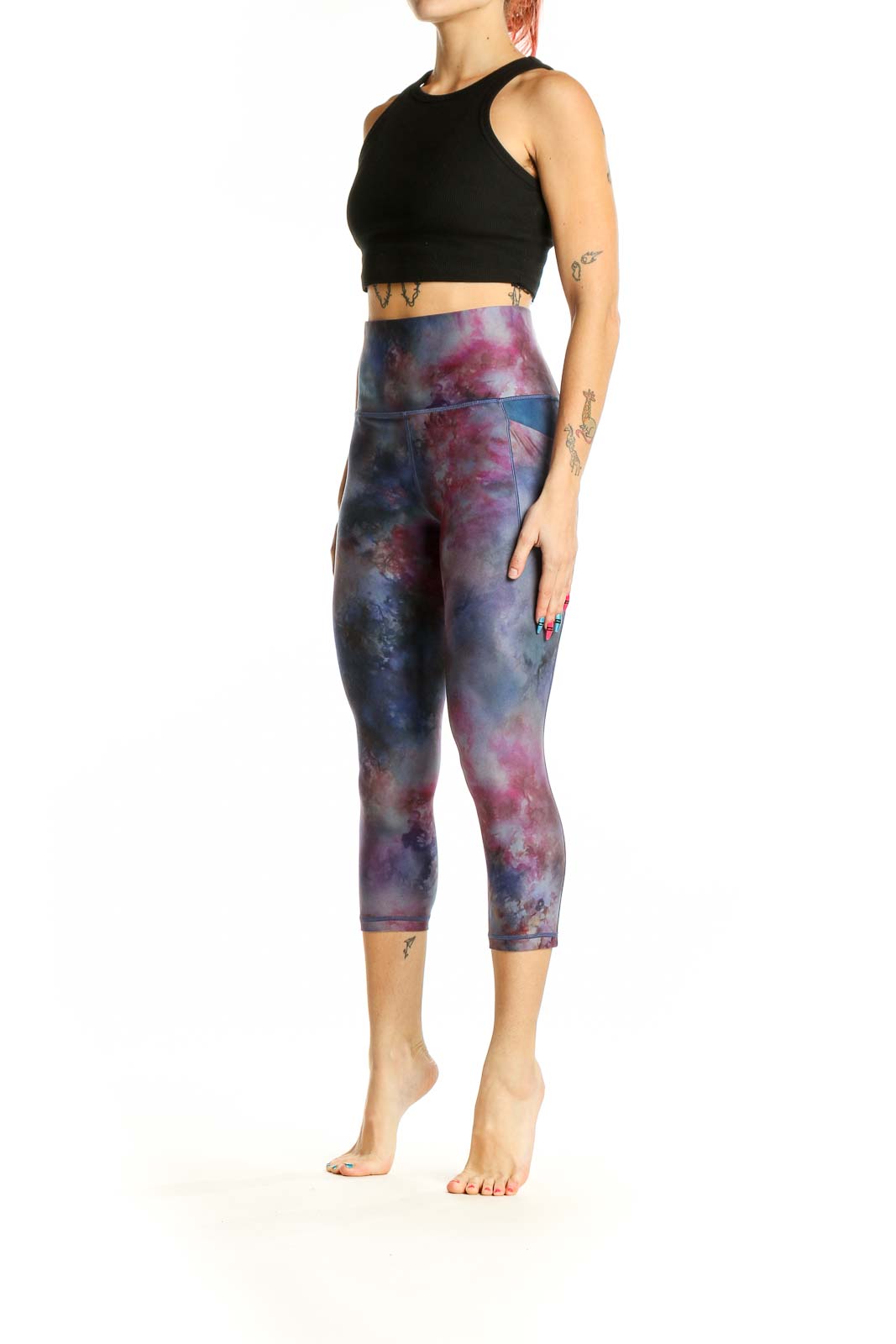 Front view of Athleta cosmic tie-dye capri leggings in blue and pink