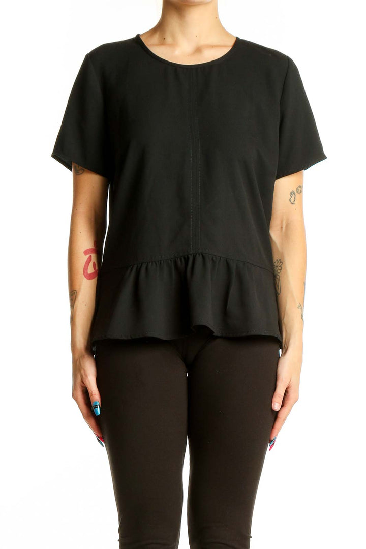 Front view of Ann Taylor black peplum top with short sleeves